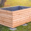 Hochbeet aus Lärchenholz steht in einem begrünten Garten