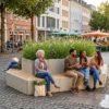 Sitzanlage aus modularen Betonblöcken mit Pflanzkübel auf Marktplatz